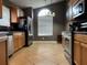 Well-lit kitchen with stainless steel appliances and beautiful tile floors, and a large window for natural light at 2061 Piedmont Park Blvd, Apopka, FL 32703