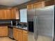 Modern kitchen with stainless steel appliances, including a refrigerator, and granite countertops at 2061 Piedmont Park Blvd, Apopka, FL 32703