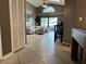 Open-concept living room featuring tile flooring, a vaulted ceiling, and a seamless transition to the outdoor living space at 2061 Piedmont Park Blvd, Apopka, FL 32703