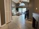 Open-concept living room featuring tile flooring, a vaulted ceiling, and a seamless transition to the outdoor living space at 2061 Piedmont Park Blvd, Apopka, FL 32703