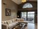Bright living room with a high ceiling, comfortable seating, and direct access to the outdoor patio area at 2061 Piedmont Park Blvd, Apopka, FL 32703