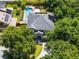 This aerial view highlights the home's mature landscaping, a pool and solar panels at 207 Via Tuscany Loop, Lake Mary, FL 32746