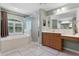Bright bathroom with a walk-in shower, large soaking tub, and wood vanity at 207 Via Tuscany Loop, Lake Mary, FL 32746