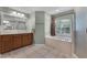 Bright bathroom with a soaking tub, walk-in shower, tile floors and wood vanity at 207 Via Tuscany Loop, Lake Mary, FL 32746