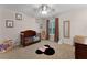 Cozy bedroom with a wooden crib, neutral carpet, and cute animal decor at 207 Via Tuscany Loop, Lake Mary, FL 32746