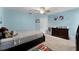 Bright bedroom with blue walls, a ceiling fan, and neutral carpet at 207 Via Tuscany Loop, Lake Mary, FL 32746