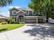 Charming two-story home featuring a spacious three-car garage and a well-manicured front lawn at 207 Via Tuscany Loop, Lake Mary, FL 32746