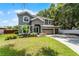 Charming two-story home featuring a spacious three-car garage and a well-manicured front lawn at 207 Via Tuscany Loop, Lake Mary, FL 32746