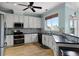 Modern kitchen with stainless steel appliances, granite countertops, and bright blue walls at 207 Via Tuscany Loop, Lake Mary, FL 32746