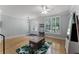 Bright living room featuring hardwood flooring, a ceiling fan, and decorative glass-paneled front door at 207 Via Tuscany Loop, Lake Mary, FL 32746