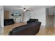 Living room with hardwood floors, ceiling fan, TV, and a staircase leading to the upper level at 207 Via Tuscany Loop, Lake Mary, FL 32746