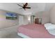 Spacious main bedroom with a ceiling fan, large television, and ample closet space at 207 Via Tuscany Loop, Lake Mary, FL 32746