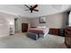 Large main bedroom featuring a neutral color scheme, tray ceilings, and plenty of storage at 207 Via Tuscany Loop, Lake Mary, FL 32746