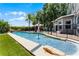 Backyard oasis featuring a sparkling pool with waterfall, lush landscaping, and safety fence at 207 Via Tuscany Loop, Lake Mary, FL 32746