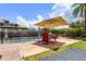 Inviting pool area with waterfall feature, patio seating, and a safety fence for added peace of mind at 207 Via Tuscany Loop, Lake Mary, FL 32746
