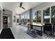 Bright sunroom with hanging chairs, tile flooring, and lots of natural light from the large windows at 207 Via Tuscany Loop, Lake Mary, FL 32746