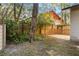 Fenced in backyard with lush greenery and small patio area at 241 Ruth Blvd, Longwood, FL 32750