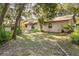 Lush backyard with mature trees, patio, and green lawn at 241 Ruth Blvd, Longwood, FL 32750