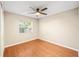 Comfortable bedroom with a ceiling fan, hardwood floors, and a window, providing a peaceful and relaxing atmosphere at 241 Ruth Blvd, Longwood, FL 32750