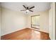 Well-lit bedroom featuring hardwood floors, a ceiling fan, and a window offering natural light and ventilation at 241 Ruth Blvd, Longwood, FL 32750