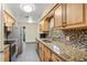 Well-lit kitchen features updated appliances, granite countertops, and modern backsplash at 241 Ruth Blvd, Longwood, FL 32750