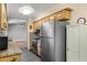Kitchen with stainless steel appliances, stone countertops, updated cabinets, and tile floors at 241 Ruth Blvd, Longwood, FL 32750