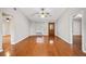 Bright living room with hardwood floors, neutral walls, and decorative wood front door at 241 Ruth Blvd, Longwood, FL 32750