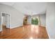 Open-concept living room with hardwood floors, neutral walls, and patio door at 241 Ruth Blvd, Longwood, FL 32750