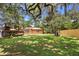 Green backyard with a deck surrounding an above ground pool and mature trees with Spanish moss at 2678 Wilmhurst Rd, Deland, FL 32720