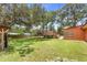 Grassy backyard with a wooden deck surrounding an above ground pool and tall mature trees at 2678 Wilmhurst Rd, Deland, FL 32720