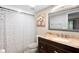 Bathroom with framed mirror, shower with curtain and dark wood vanity with white sink at 2678 Wilmhurst Rd, Deland, FL 32720