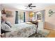 Cozy bedroom with ceiling fan, soft natural light, and comfortable bed with decorative pillows at 2678 Wilmhurst Rd, Deland, FL 32720