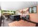 Covered patio with a hot tub, seating, and privacy curtains providing a relaxing outdoor space at 2678 Wilmhurst Rd, Deland, FL 32720
