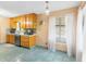 Cozy kitchen with oak cabinets, blue ceramic tile floor and backsplash, and stainless steel dishwasher at 2678 Wilmhurst Rd, Deland, FL 32720