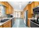 Classic galley kitchen features stainless steel appliances and ample wood cabinetry at 2678 Wilmhurst Rd, Deland, FL 32720