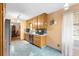 Galley kitchen features oak cabinets, stainless steel appliances, and blue tile floors at 2678 Wilmhurst Rd, Deland, FL 32720