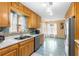 Galley kitchen features oak cabinets, stainless steel appliances, and blue tile floors at 2678 Wilmhurst Rd, Deland, FL 32720