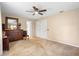Neutral main bedroom with ceiling fan, carpet flooring and large dresser at 2678 Wilmhurst Rd, Deland, FL 32720