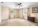 Main bedroom with ceiling fan, neutral paint color and carpet at 2678 Wilmhurst Rd, Deland, FL 32720