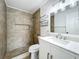 Updated bathroom featuring tiled shower and modern vanity at 3247 Forest Oaks Ct # 116, Winter Park, FL 32792