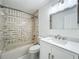 Bathroom featuring shower-tub, white vanity and neutral tiling at 3247 Forest Oaks Ct # 116, Winter Park, FL 32792