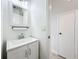 Updated bathroom featuring a sleek vanity, stylish mirror, and white walls at 3247 Forest Oaks Ct # 116, Winter Park, FL 32792
