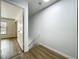 Hallway landing featuring wood floors, open door, stairs and natural light at 3247 Forest Oaks Ct # 116, Winter Park, FL 32792