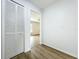 Bright hallway features wood floors, closet, and doorway to bedroom at 3247 Forest Oaks Ct # 116, Winter Park, FL 32792