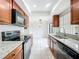 Updated kitchen with granite countertops, stainless steel appliances and tile floors at 3247 Forest Oaks Ct # 116, Winter Park, FL 32792