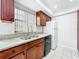 Bright kitchen featuring granite countertops, stainless steel sink, and plenty of cabinet space at 3247 Forest Oaks Ct # 116, Winter Park, FL 32792
