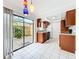 Stylish kitchen with updated cabinets, white appliances, and a view of the patio at 3247 Forest Oaks Ct # 116, Winter Park, FL 32792