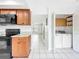View of kitchen area adjacent to the laundry closet and with a view to the living room at 3247 Forest Oaks Ct # 116, Winter Park, FL 32792