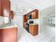 Bright kitchen features granite counters, stainless appliances, and white tile flooring at 3247 Forest Oaks Ct # 116, Winter Park, FL 32792