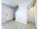 Inviting living room area with tile flooring, front door entry and staircase at 3247 Forest Oaks Ct # 116, Winter Park, FL 32792